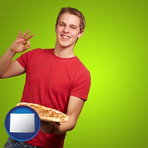 a happy teenager holding a take-out pizza - with Wyoming icon