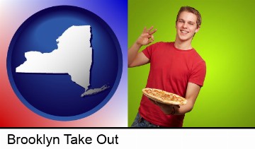 a happy teenager holding a take-out pizza in Brooklyn, NY