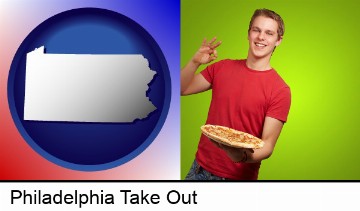 a happy teenager holding a take-out pizza in Philadelphia, PA